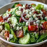 Colorful Greek Salad Bowl featuring crunchy vegetables and creamy feta cheese, tossed in a homemade tangy Greek vinaigrette.