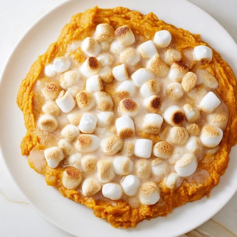 This sweet potato casserole features a creamy, mashed sweet potato base, ready to enjoy.