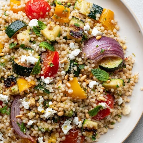 Golden roasted zucchini, bell peppers, and red onion tossed with fluffy couscous and a bright lemon dressing.  