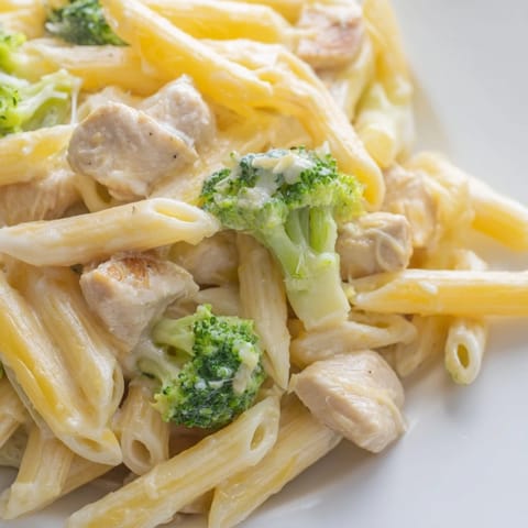 Golden brown chicken pieces, tender green broccoli florets, and al dente penne pasta tossed in a creamy, homemade cheddar cheese sauce.  