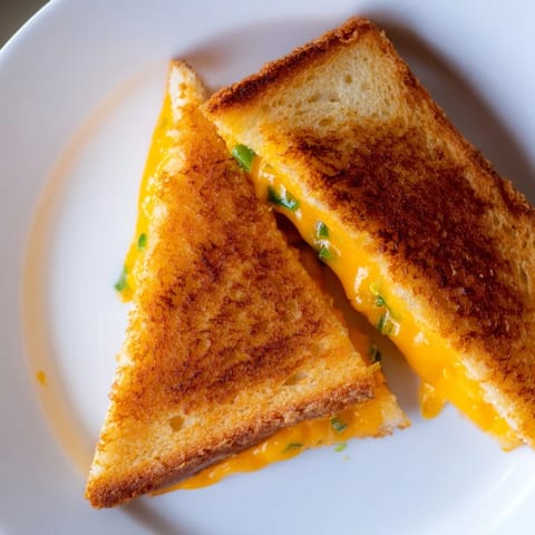 Creamy jalapeño popper grilled cheese with melted sharp cheddar and fresh peppers on golden, buttery sourdough slices.