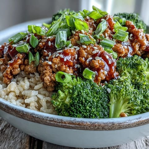 Topped with fresh green onions and sesame seeds, this Sweet and Spicy Turkey Broccoli Bowl is a vibrant, easy dinner.