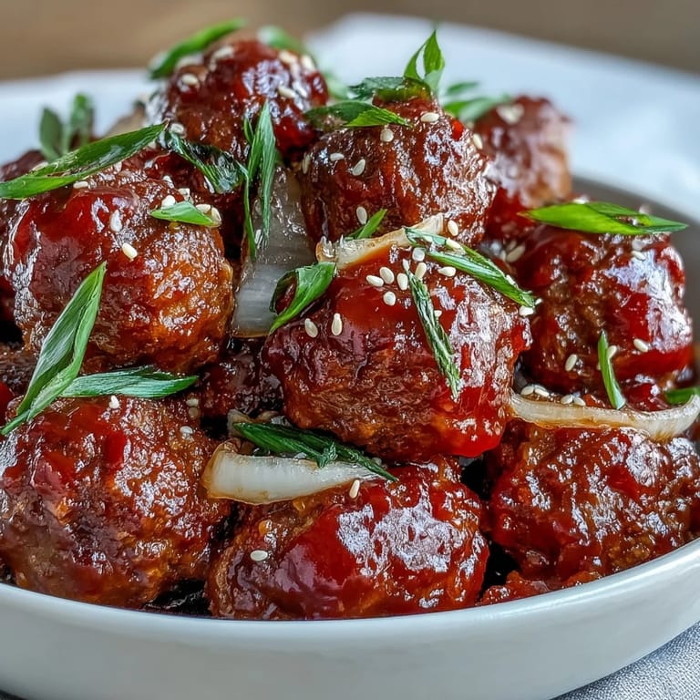 Tender Easy Sweet and Sour Crock Pot Meatballs simmered in a sweet apricot-ketchup glaze, ready to serve as a party appetizer.