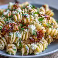 A colorful pasta salad with sweet corn, Cotija cheese, and zesty lime, perfect for summer cookouts.